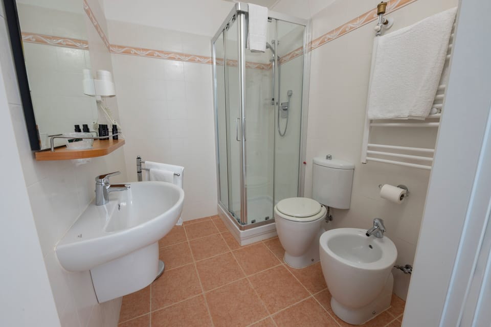 Deluxe Triple Room, Balcony, Sea View | Bathroom | Shower, hair dryer, bidet, towels
