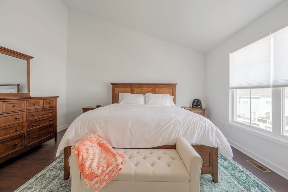 Crisp white bedding and classic wood furniture make this king bedroom a cozy retreat.
