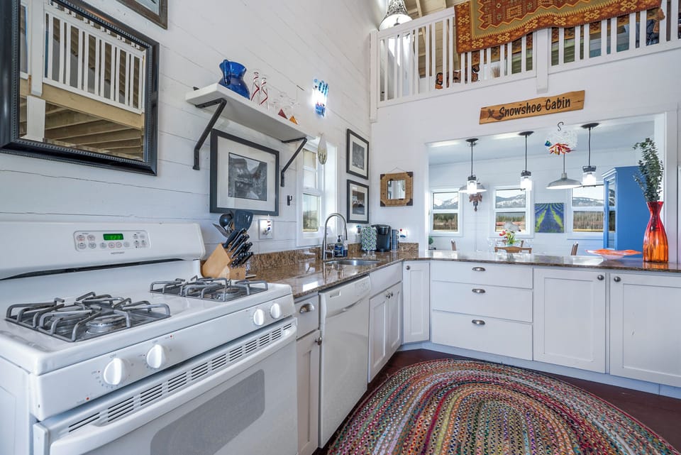 Full kitchen complete with utensils, dishware, glasses, and cookware. 
