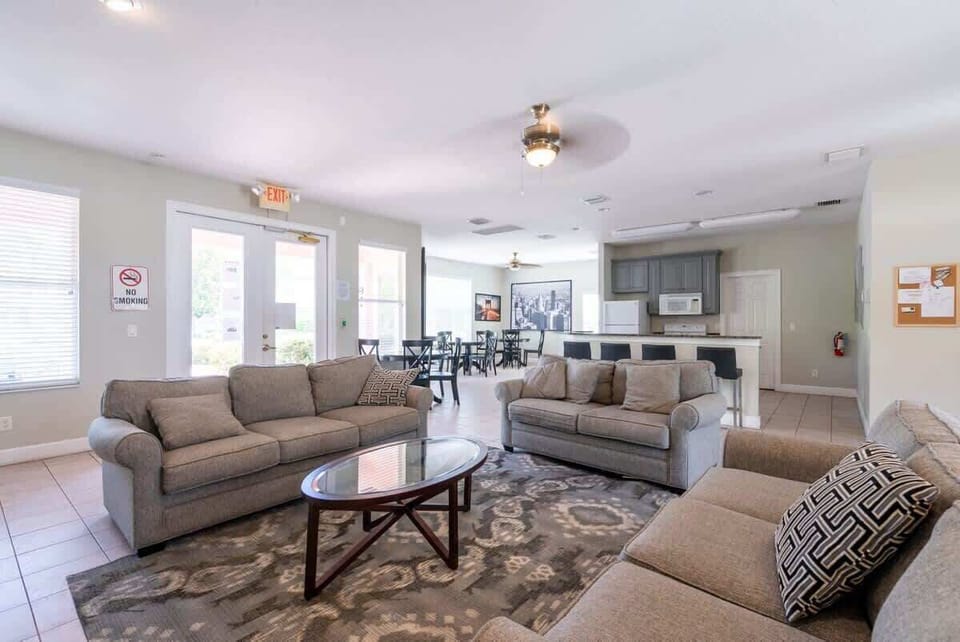 Spacious communal lounge with comfortable seating and a kitchen area for group gatherings.