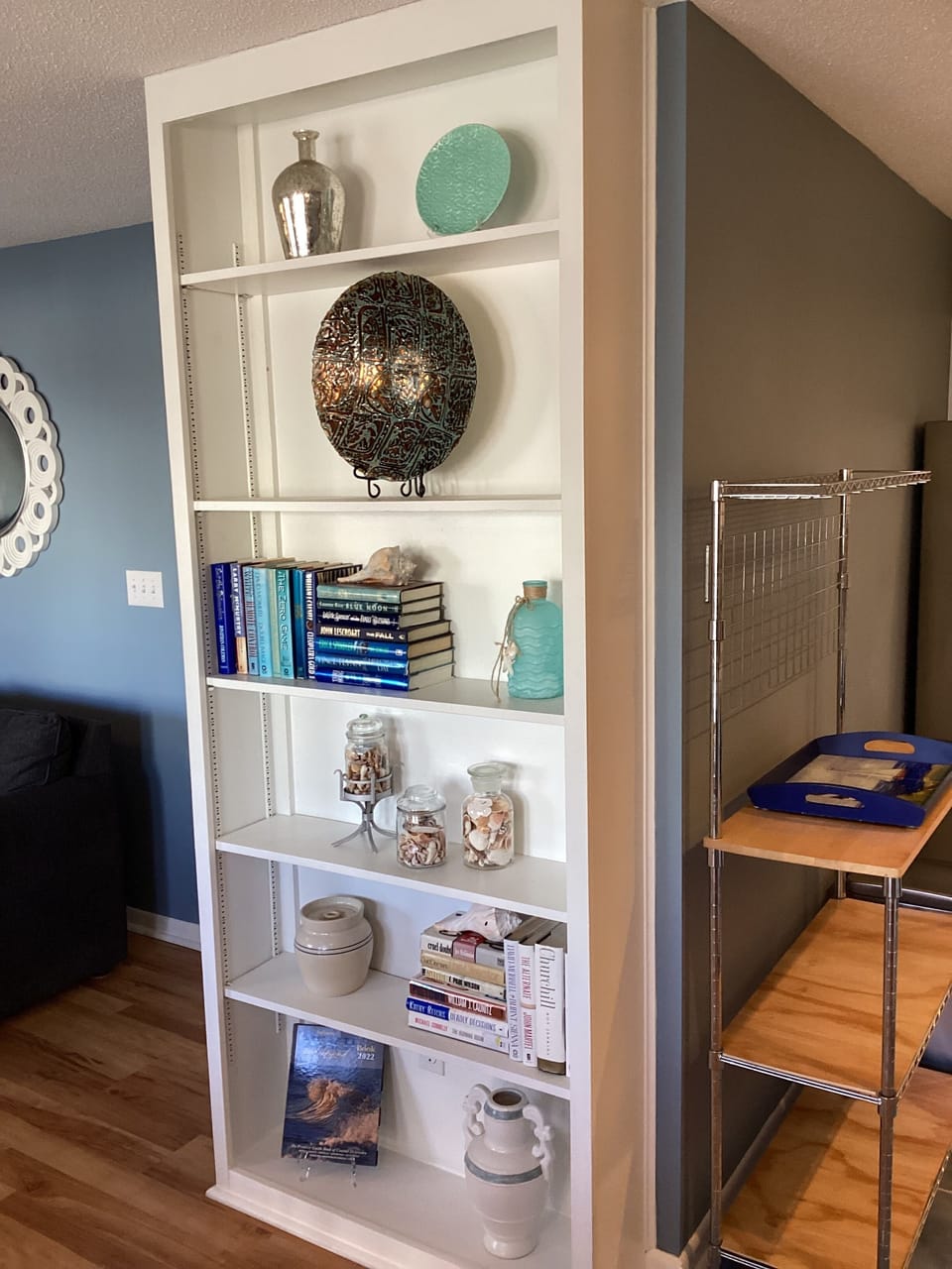 Nicely decorated Living area with bookshelves.