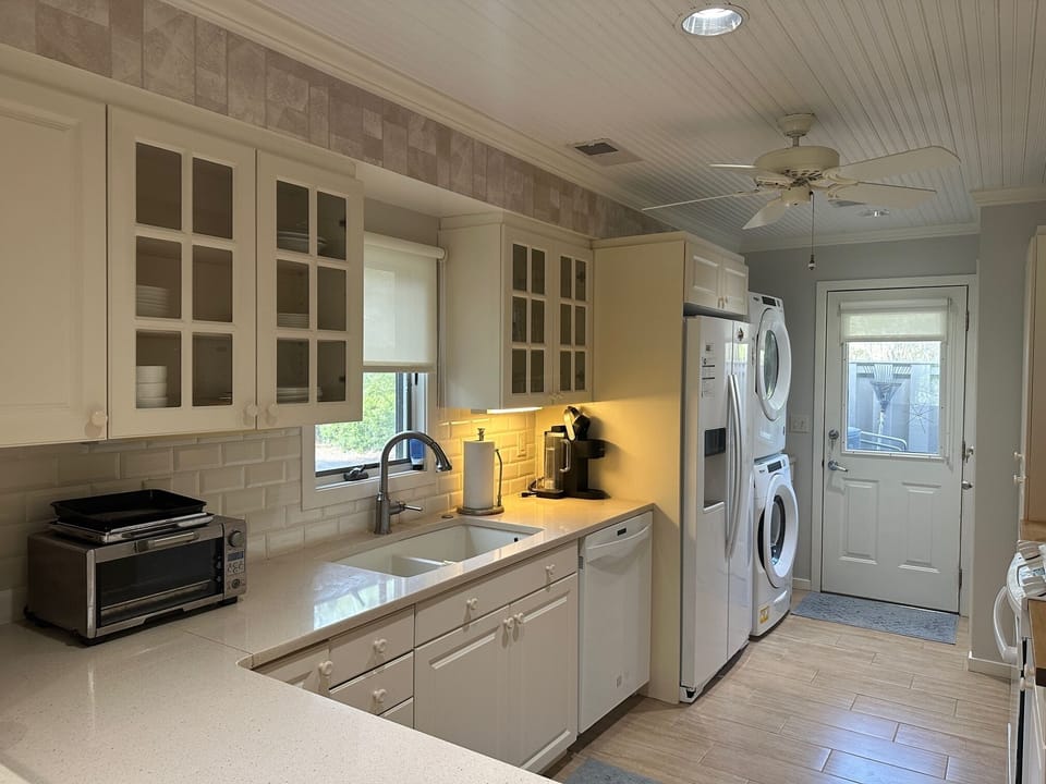 Fully equipped kitchen with plenty of counter space; washer and dry at rear.