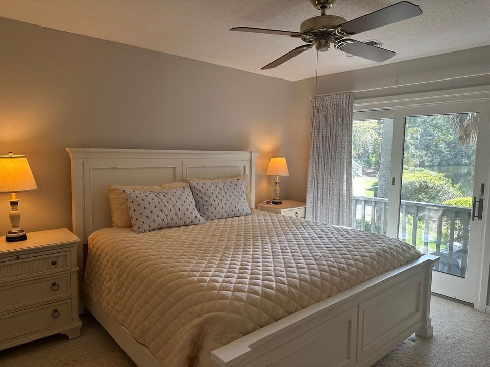 Primary bedroom- King bed, bathroom ensuite, TV, pretty view of lagoon.