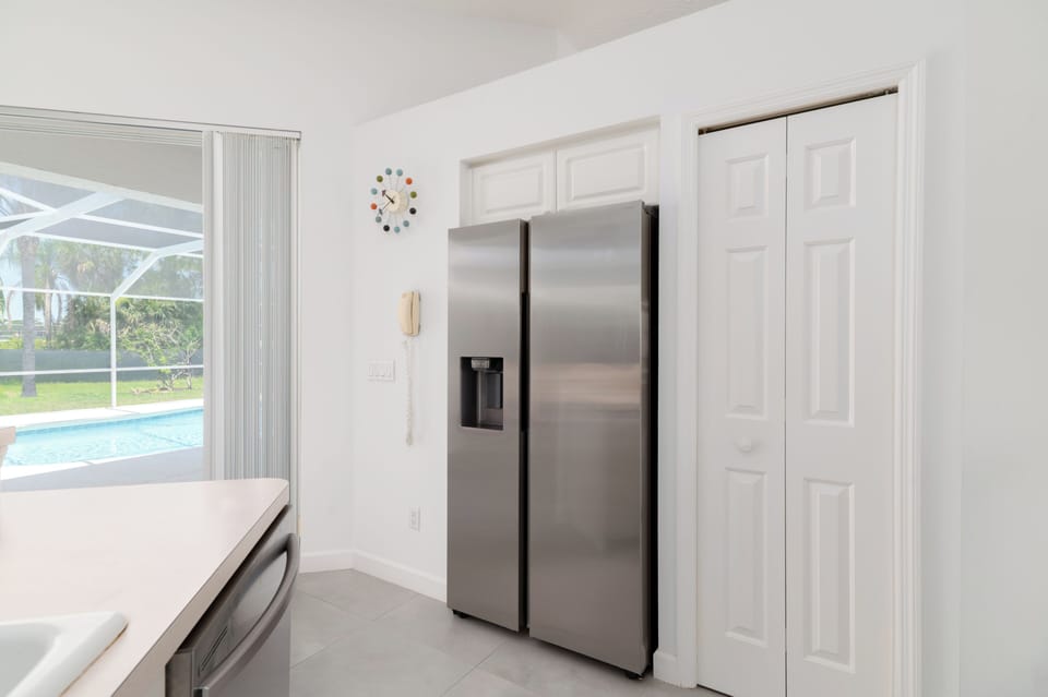 Pantry closet next to refrigerator 
