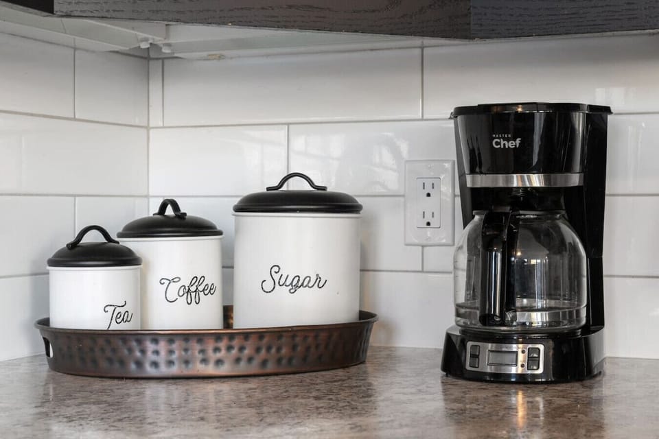 Full kitchen with an electric kettle, instapot, drip coffee maker, ground coffee, tea & sugar.