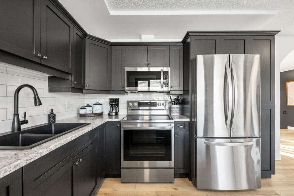 Full kitchen with an electric kettle, instapot, drip coffee maker, ground coffee, tea & sugar.