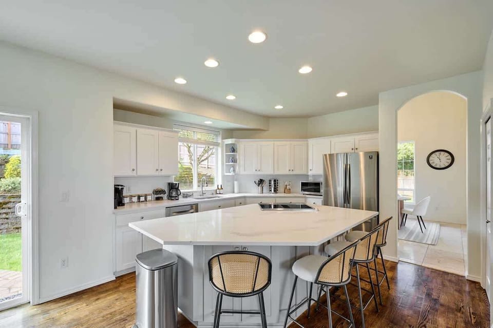 Whip up anything from quick bites to gourmet feasts in this modern kitchen with an expansive island, cozy nook, and all the cookware you need
