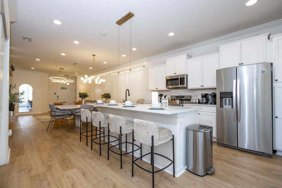 Spacious kitchen with sleek appliances and breakfast bar seating
