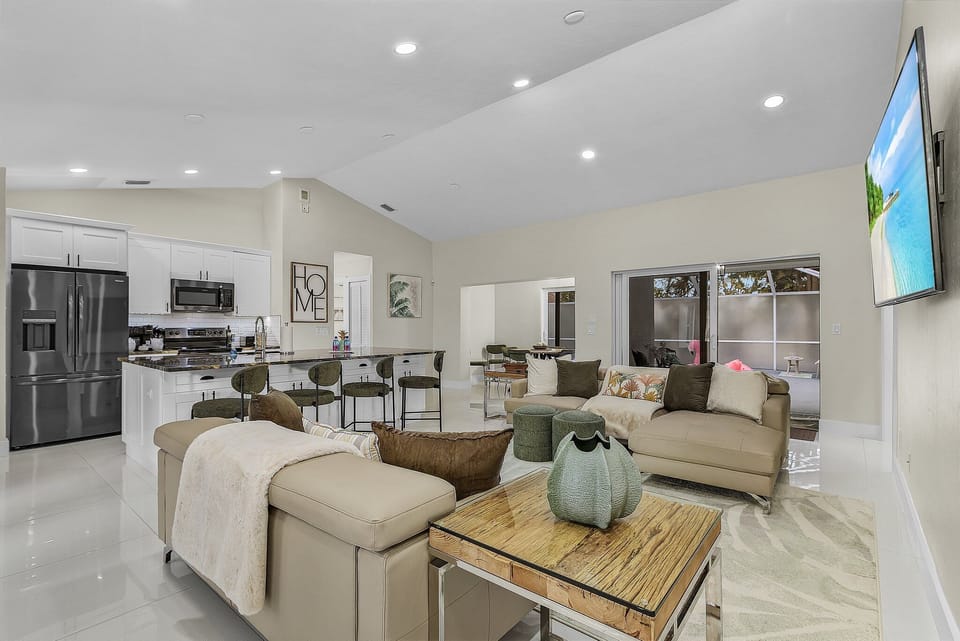 The Living Room, Kitchen and Dining Room all share the same bright and inviting open concept space