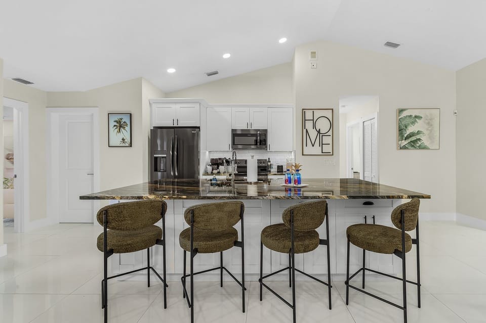 The kitchen island has seating where you can gather for coffee and snacks