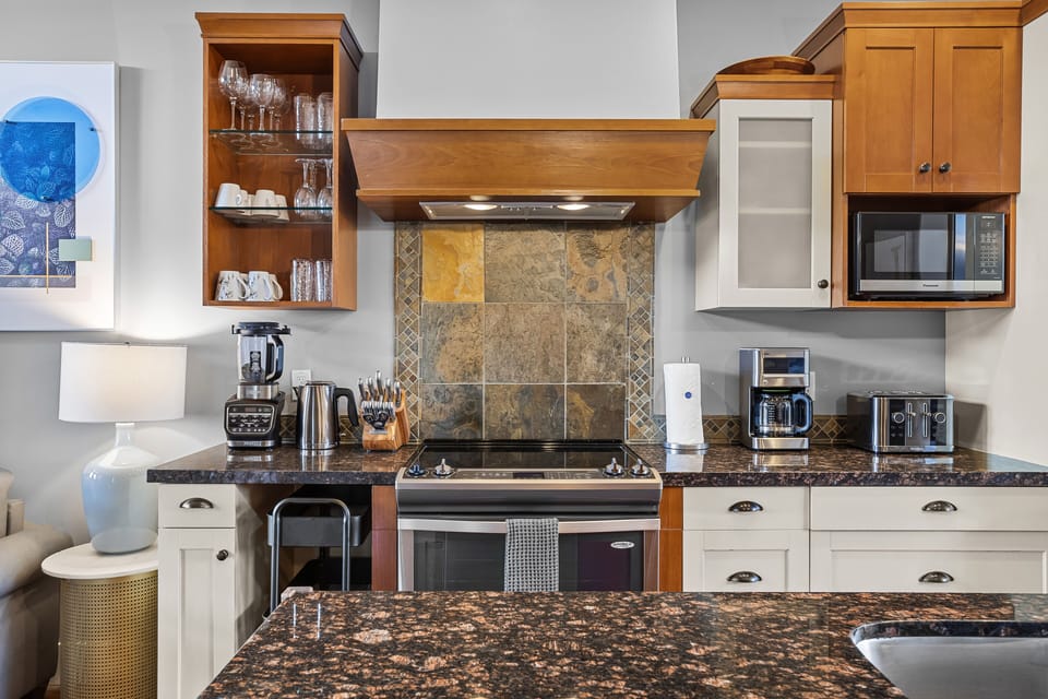 Fully equipped kitchen with stainless steel appliances and a large island.