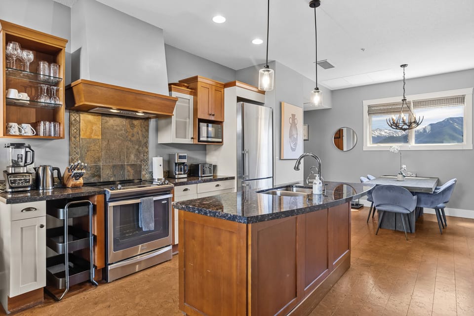 Fully equipped kitchen with stainless steel appliances and a large island.