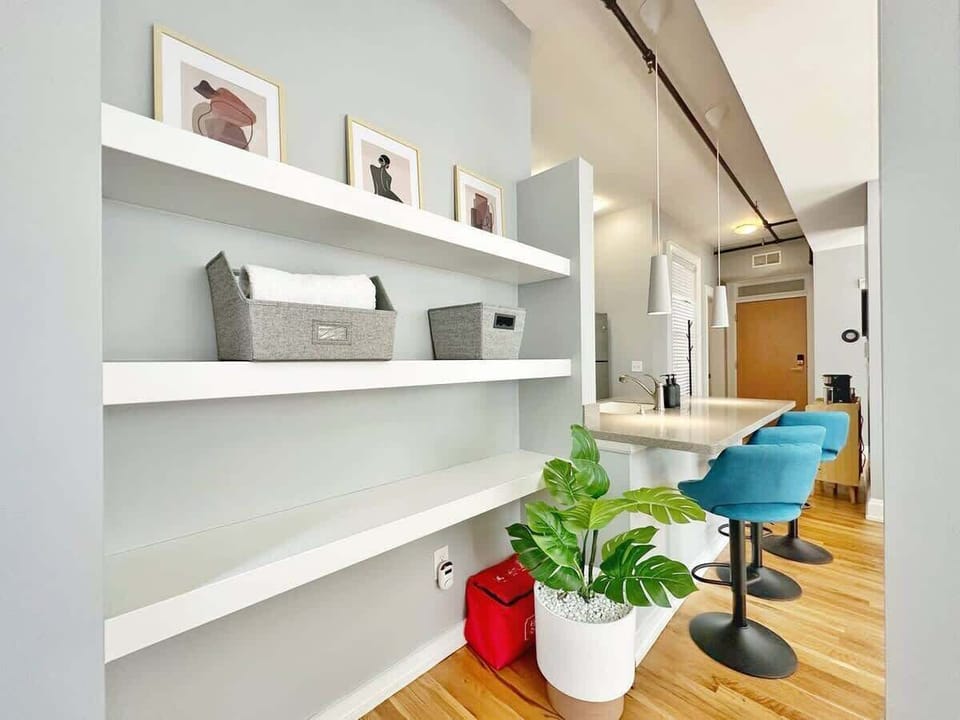 - Built in shelving with organized storage and modern decor accents  
- Bright clean setup ideal for short term rental guests  
- Functional area offering convenience and style  
