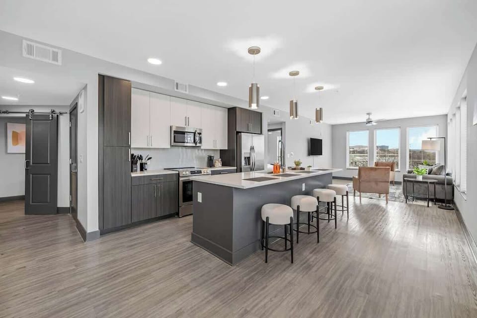 - Spacious  shared  kitchen with island seating and stainless appliances for easy cooking  
- Open floor plan perfect for group gatherings  
- Bright windows filling the space with warm natural light  