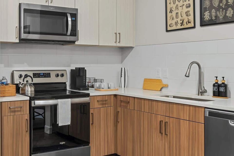 - Modern kitchen with stainless stove microwave and bright wood cabinets  
- Fully equipped setup perfect for home cooking longer stays and comfort  
- Clean layout brings easy meal prep smooth flow and pleasant workspace
