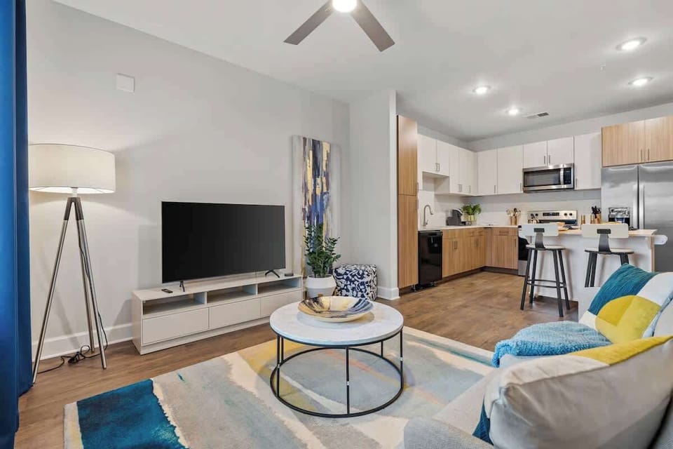 - Open living area with TV cozy seating and bright accents  
- Great layout connecting living and kitchen for easy flow  
- Perfect for relaxing streaming or gathering with friends  