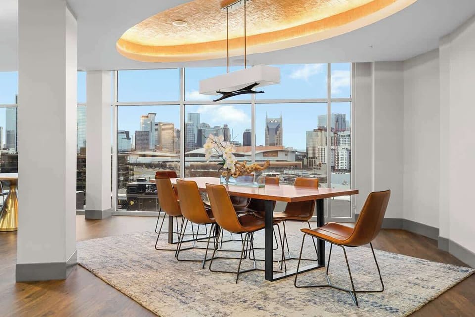 -  Shared Dining area with skyline views and stylish seating  
- Floor to ceiling windows create a bright inviting vibe  
- Great space for meals gatherings and city sunsets  
