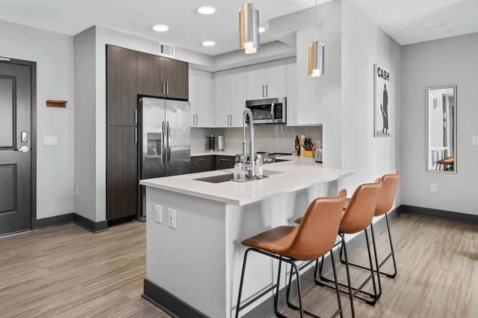 - Sleek shared kitchen with stainless appliances and island seating  
- Bright layout ideal for cooking and quick meals  
- Modern rental with stylish finishes throughout  