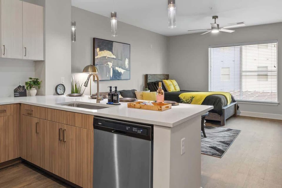 - Modern shared kitchen layout with bright island and stainless appliances  
- Open flow ideal for short term rental guests seeking convenience  
- Spacious design perfect for cooking and relaxing during stays  
