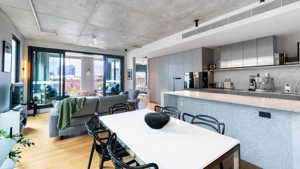 Gather around the dining table in a stylish open-plan space