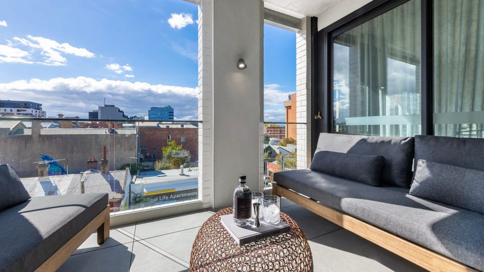 Relax in the sunlit lounge with sweeping city views