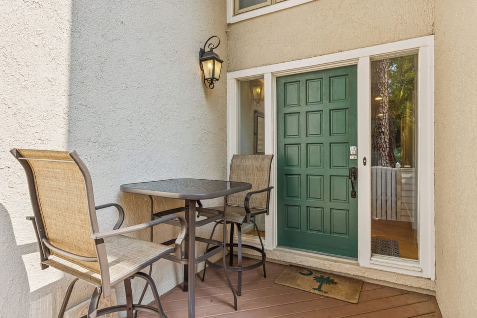High top table with 2 chairs located at the front of villa
