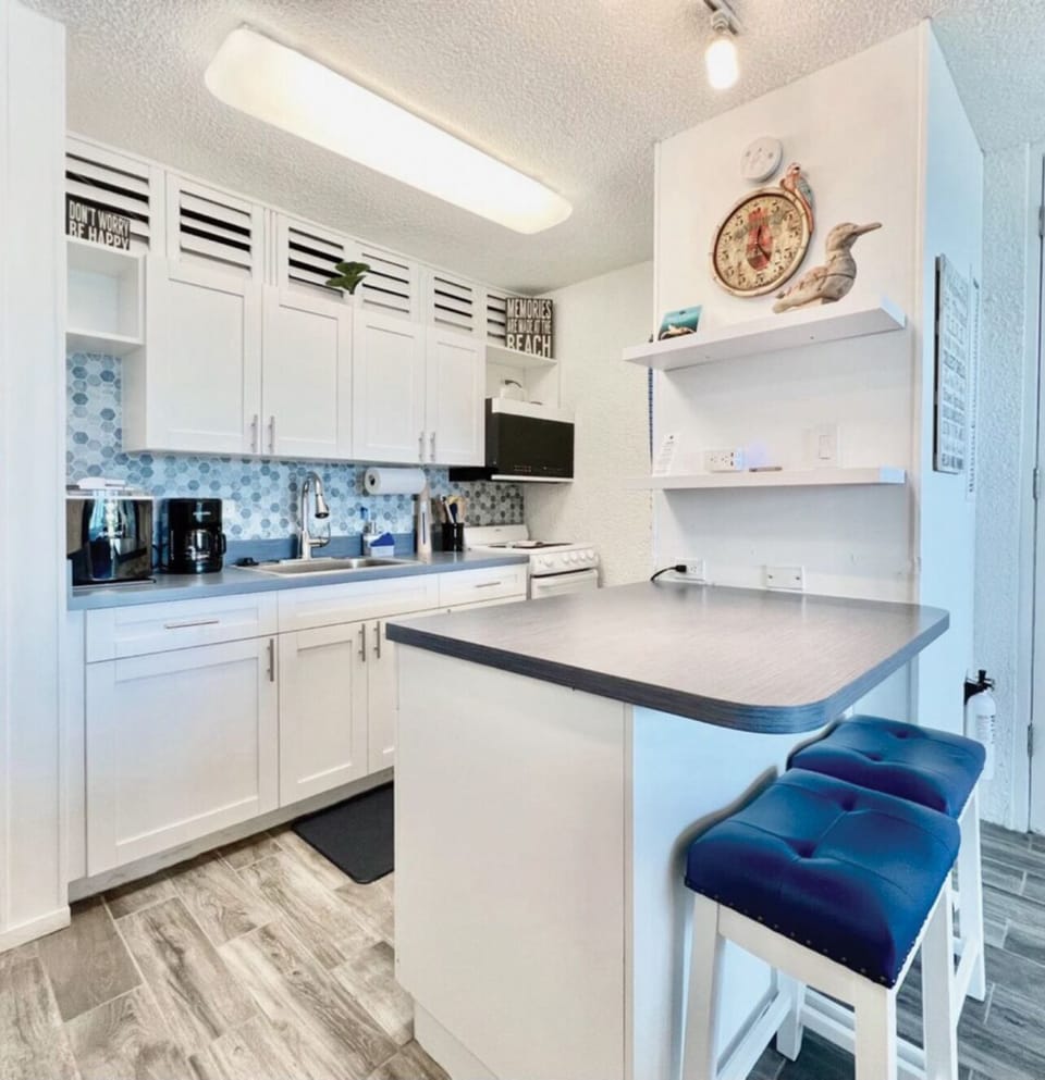 Another view of the kitchen showing seating area.