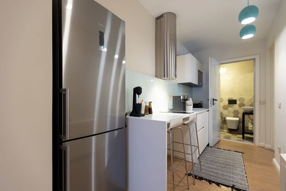 The fully equipped kitchen has all modern appliances, a GAGGENAU stove & microwave, perfect for a self-catered holiday, and a breakfast bar with two stools.