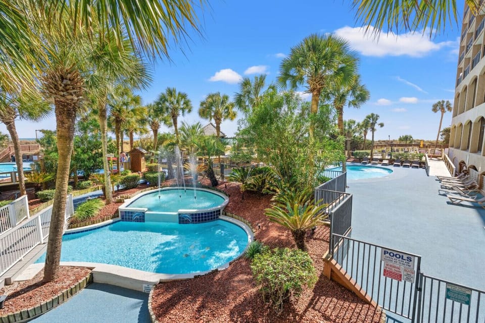 Iconic Tropically themes Beach Cove Resort with pools, hot tubs, poolside beach bars, and fountains.