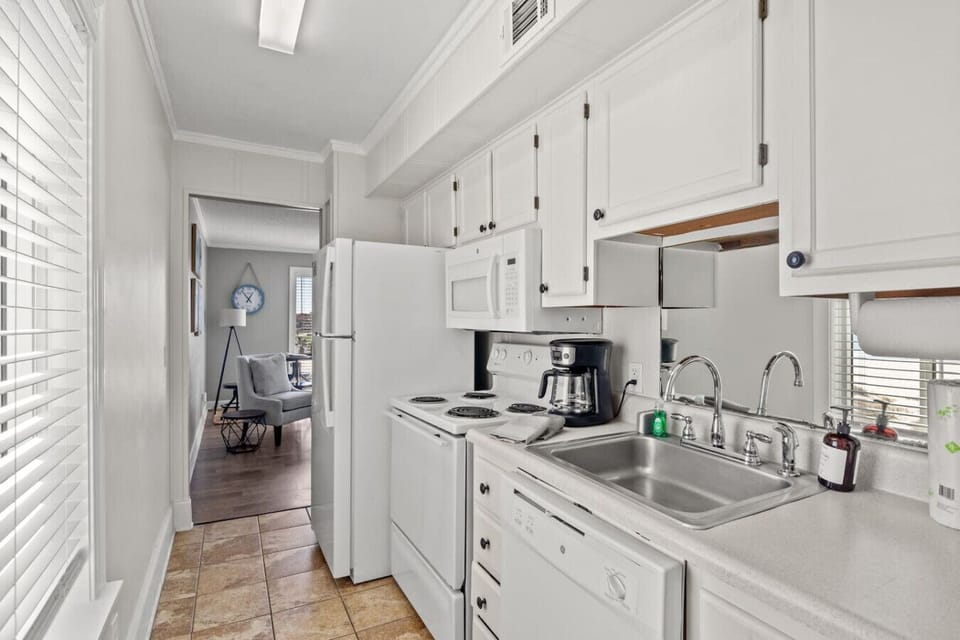 This kitchen is fully stocked with all the amenities of home. Enjoy whipping up a vacation meal, preparing a morning coffee. The kitchen includes: sink, stove, oven, microwave, refrigerator, drip coffee maker, dishwasher, and plenty of cabinet space.