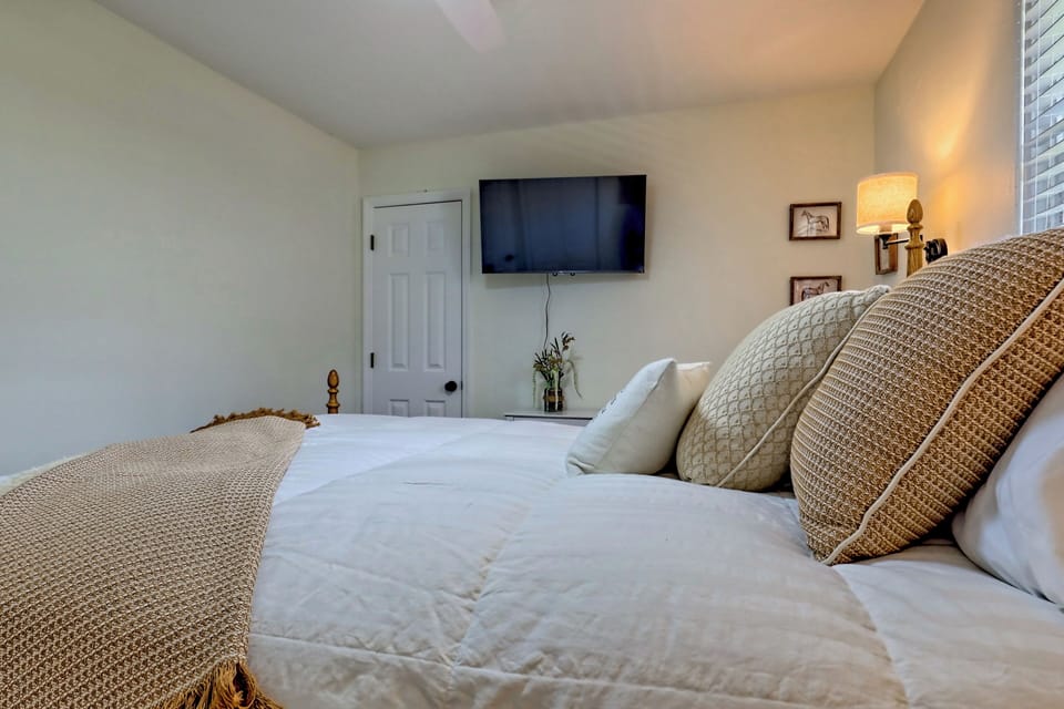 Third bedroom with queen sized bed, door to shared bathroom. 