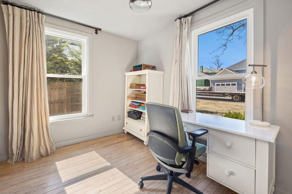 This home also has an additional room that features a desk and chair, providing a comfortable workspace for remote work, studying, or personal projects.