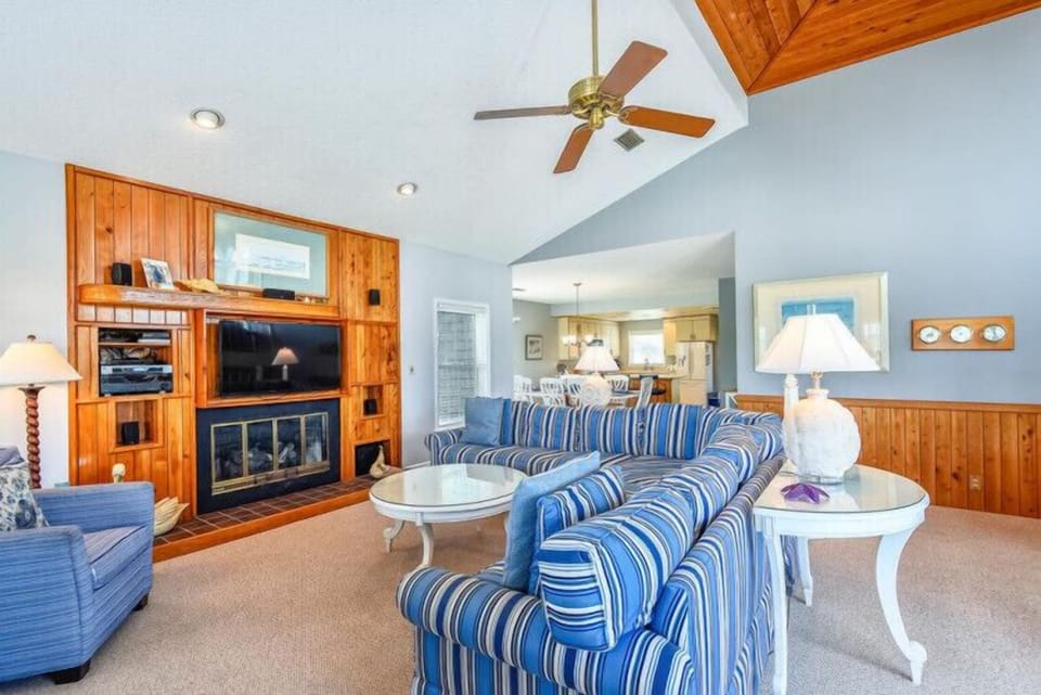 Relax in your open-concept living space with vaulted ceilings, cozy fireplace, and coastal-inspired décor that invites you to unwind after a day of exploring.