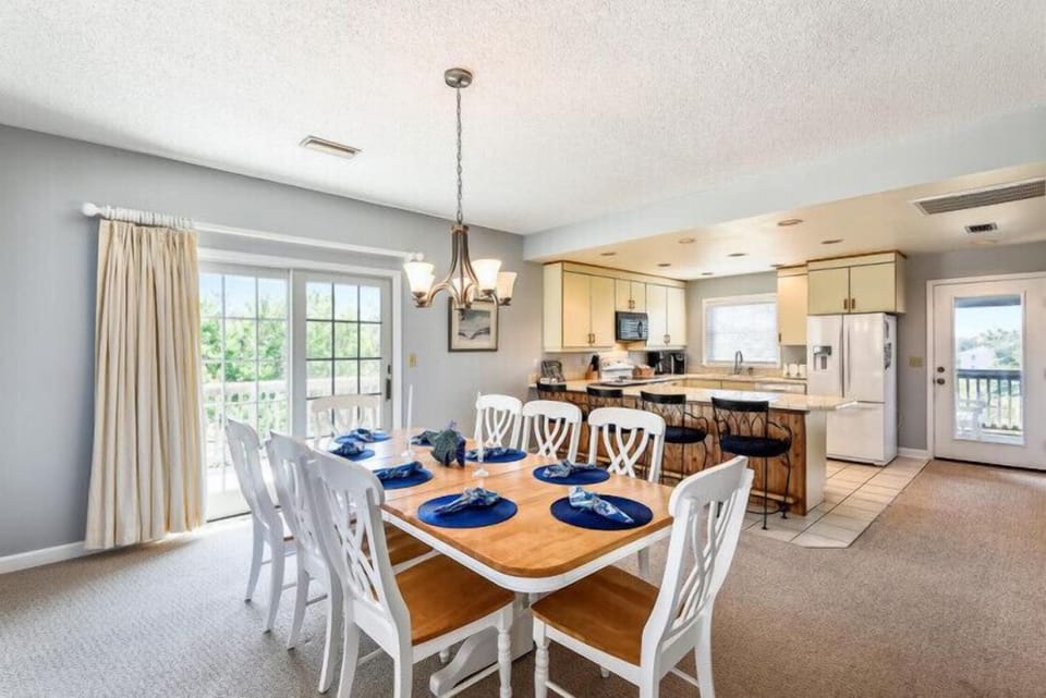 Gather around your dining table for meals together, with natural light streaming in and an open kitchen nearby ready for cooking and conversation.