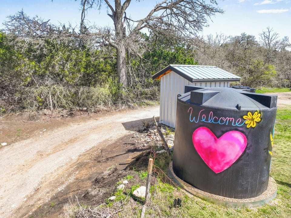Private drive up to the home with welcoming artwork