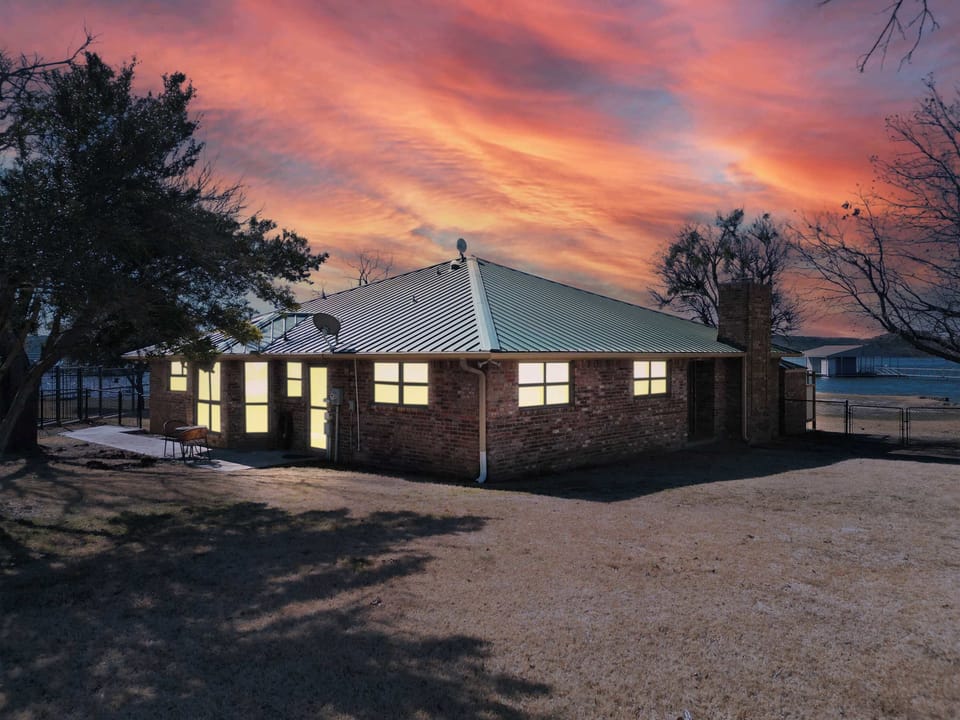 Cozy brick lake house with a spacious yard, perfect for enjoying stunning sunsets over Possum Kingdom Lake.