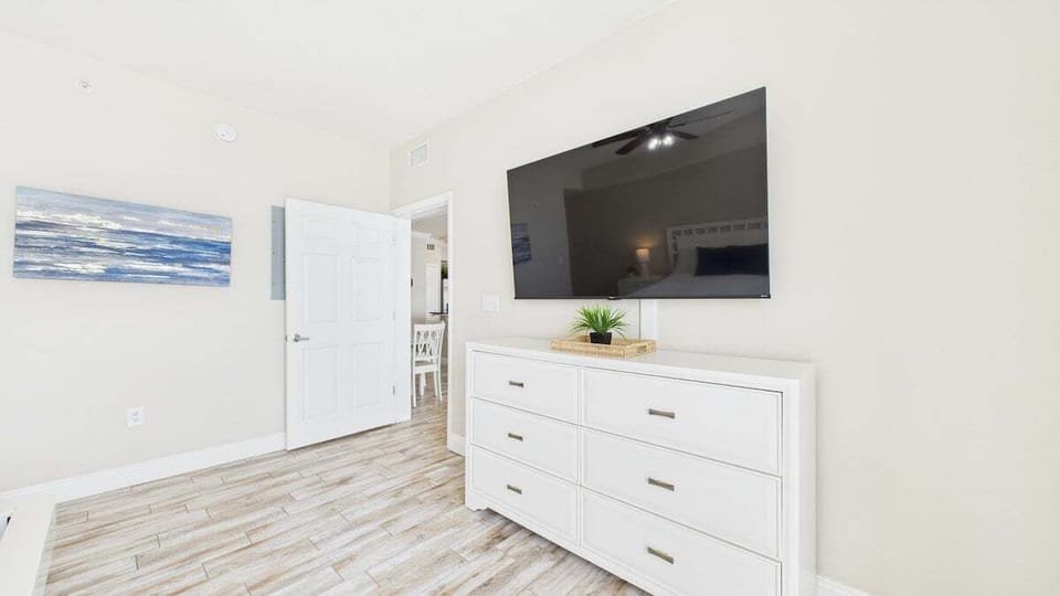 Master bedroom with king bed TV ensuite bathroom and balcony access