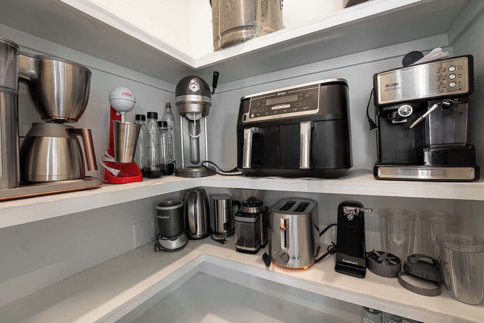 A well-stocked appliance shelf for all your cooking needs.