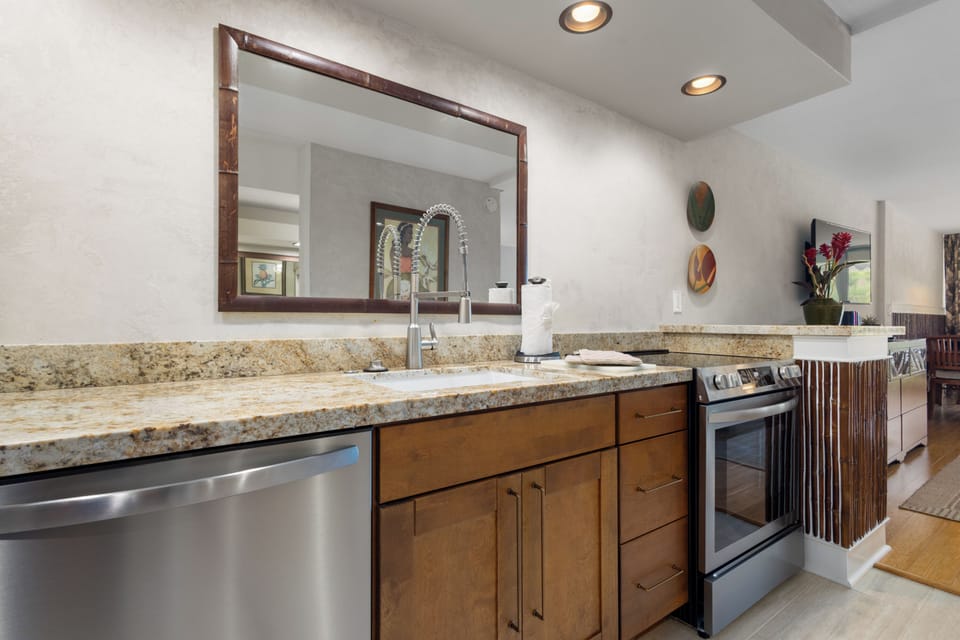 Prepare your favorite meals in this modern kitchen featuring granite countertops, stainless steel appliances, and everything you need for a home-away-from-home experience.