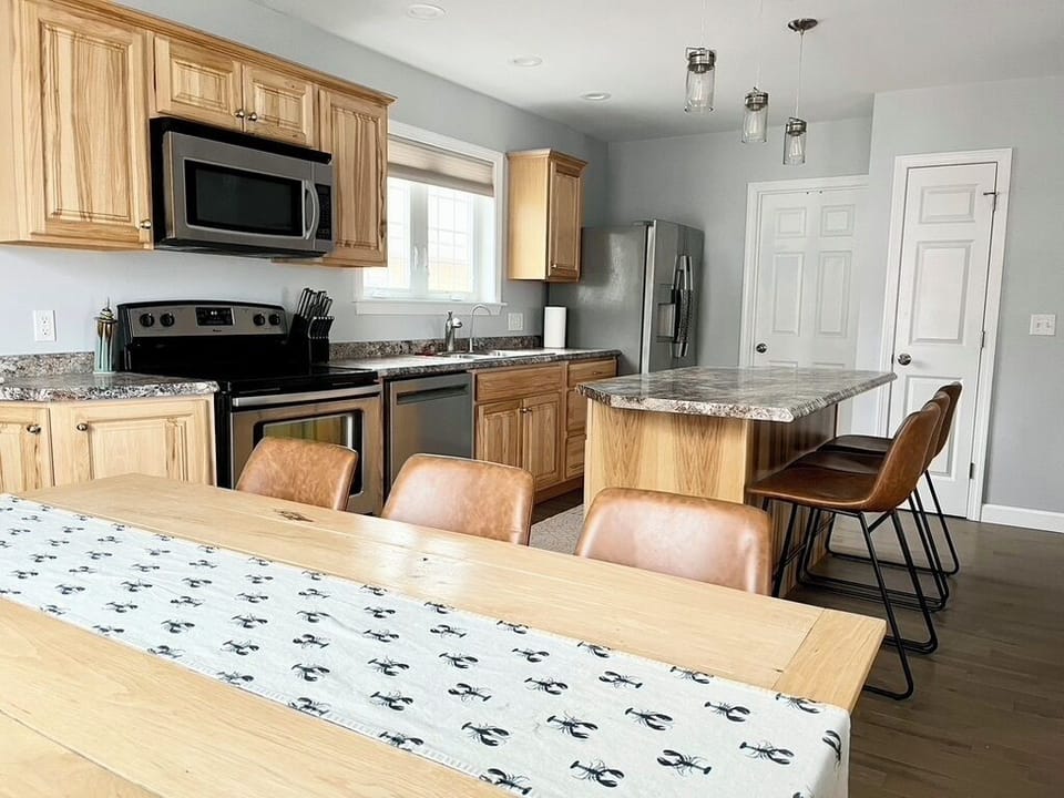 Dining table open to fully equipped kitchen