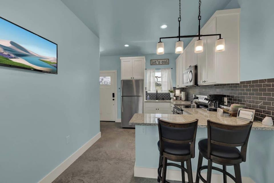 Enjoy casual meals or morning coffee at the cozy countertop dining space for two, perfect for relaxed vacation moments.