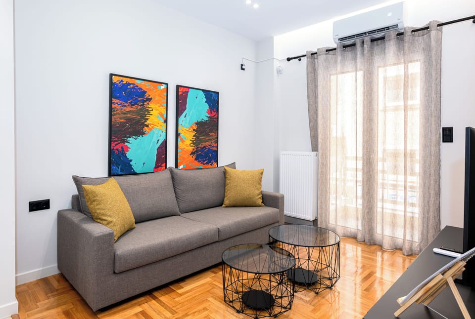 Bright, modern living space with cosy sofa and vibrant artwork.