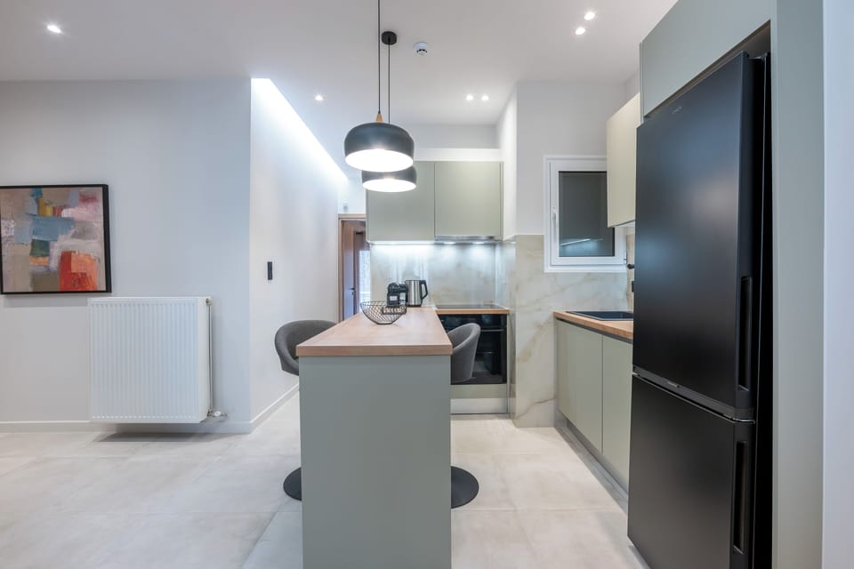 Modern kitchen with sleek design, stylish lighting, and spacious dining area.