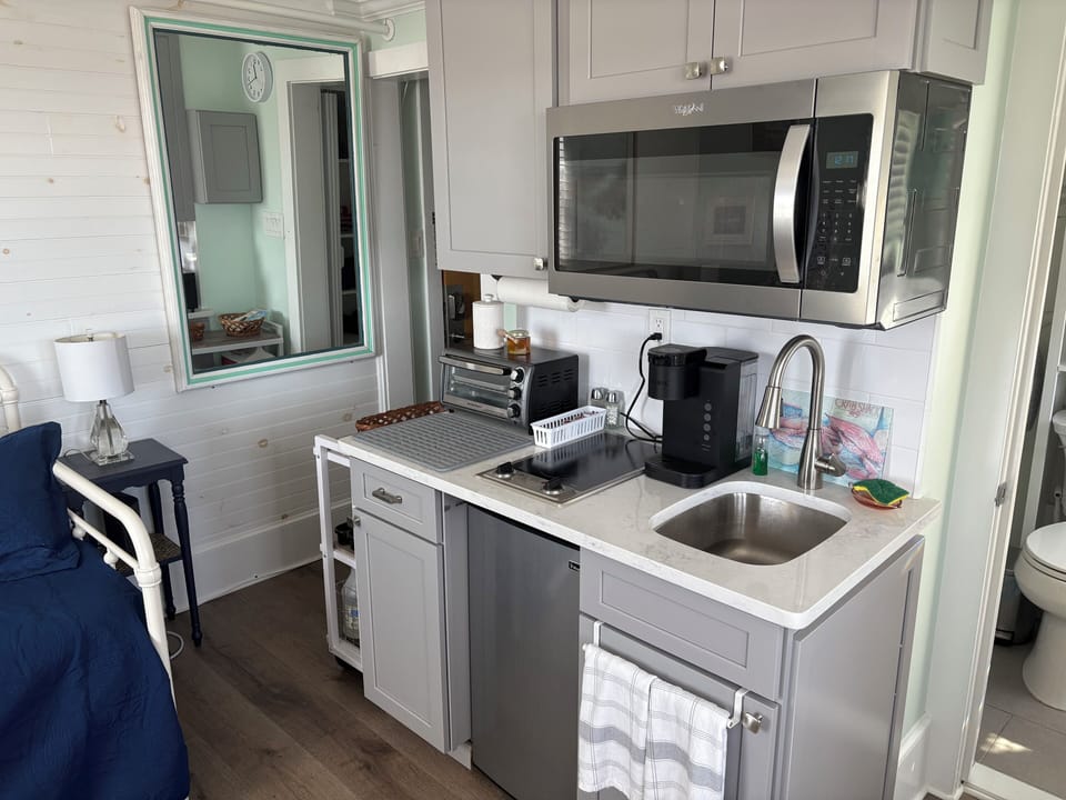 Kitchenette with microwave, toaster, keurig, electric stovetop, mini fridge