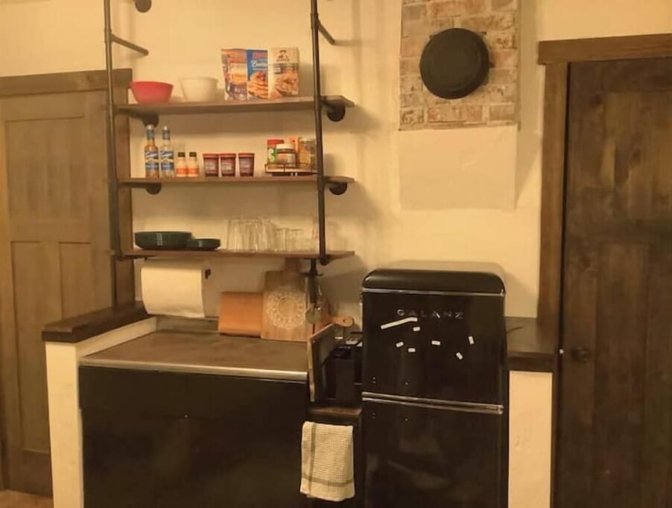 Kitchen is fully equipped with griddle, hot plate, refrigerator, coffee maker