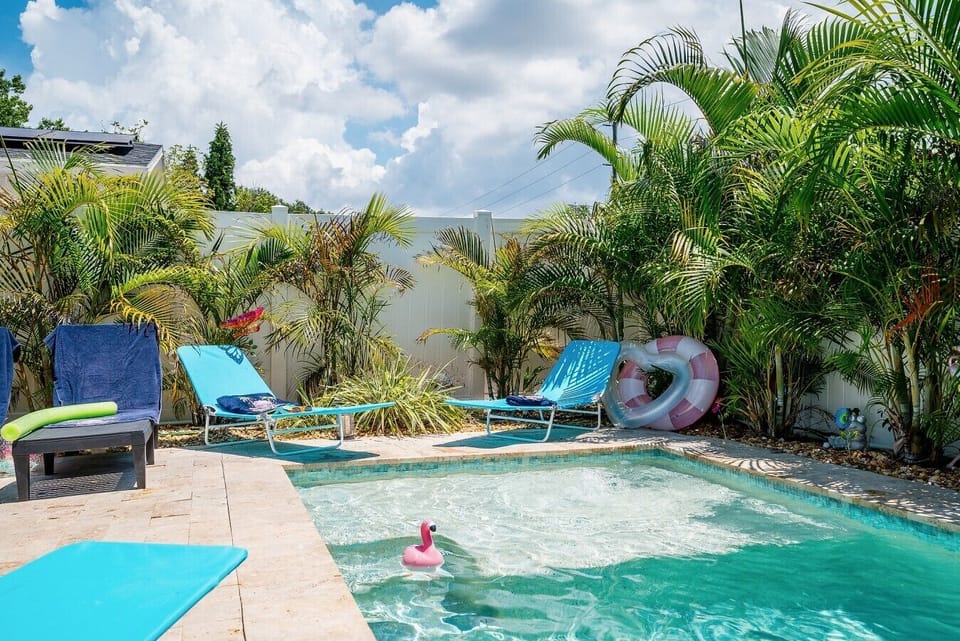 Private pool deck with lounge chairs, pool noodles, and floats included. Fully fenced, tropical landscaping, sleeps 10. Gulfport/South St. Pete, FL.