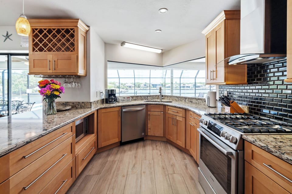 Cabinets have many pots & pans, lots of utensils, kitchen tools, bowls, etc.