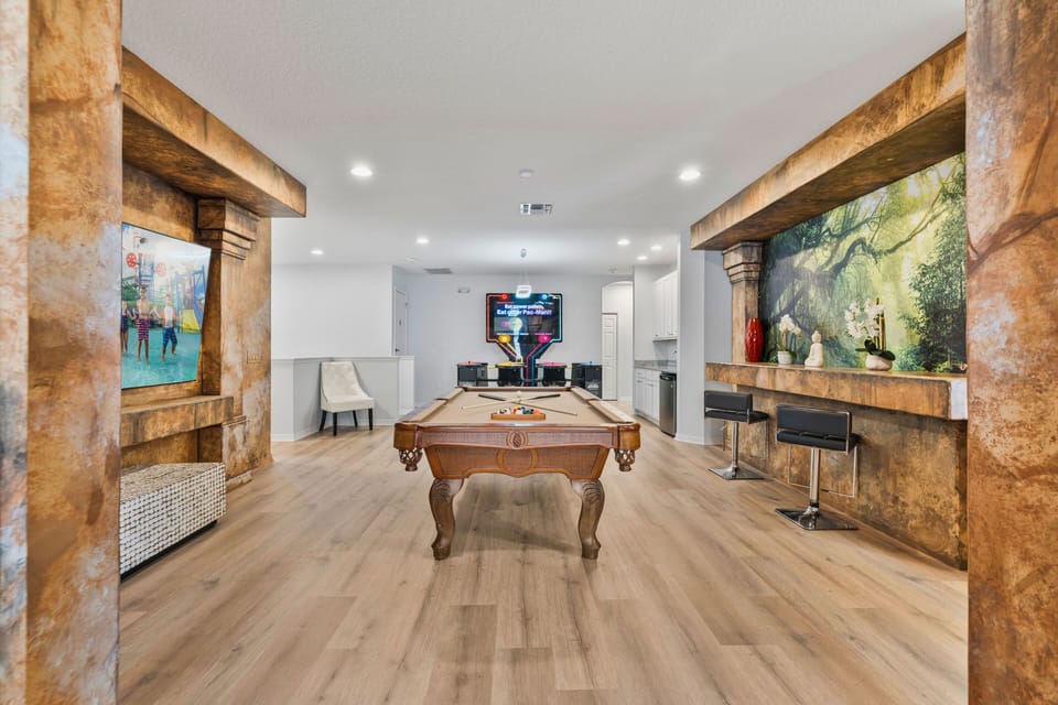 - Themed lounge area with custom mural and bar  
- Large Orlando vacation rental with movie theater  
- Perfect villa for family reunions near Disney