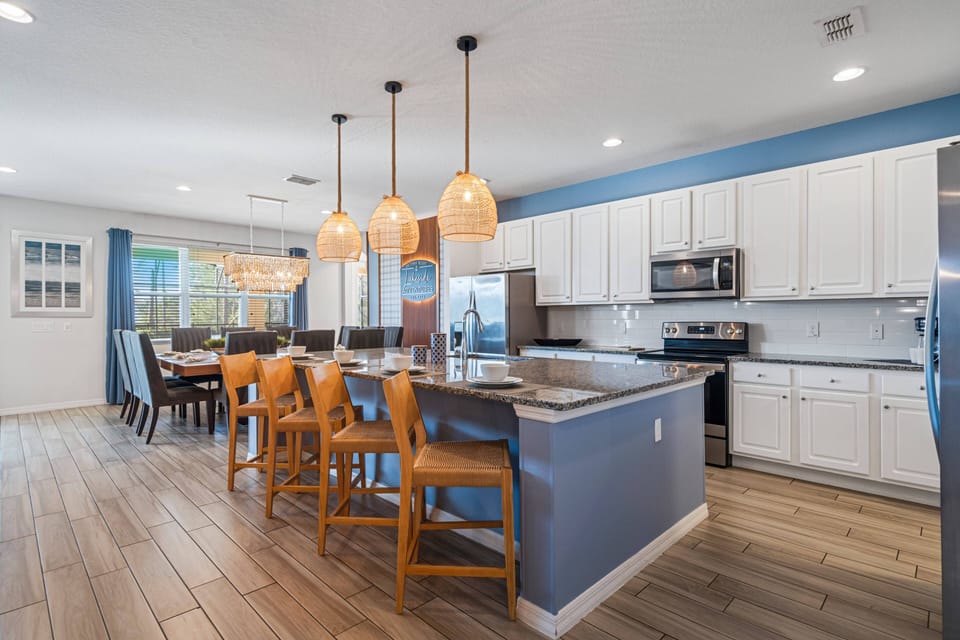 - Open kitchen with granite counters and bar seating  
- Spacious Orlando vacation rental with modern design  
- Family-friendly villa close to Disney attractions