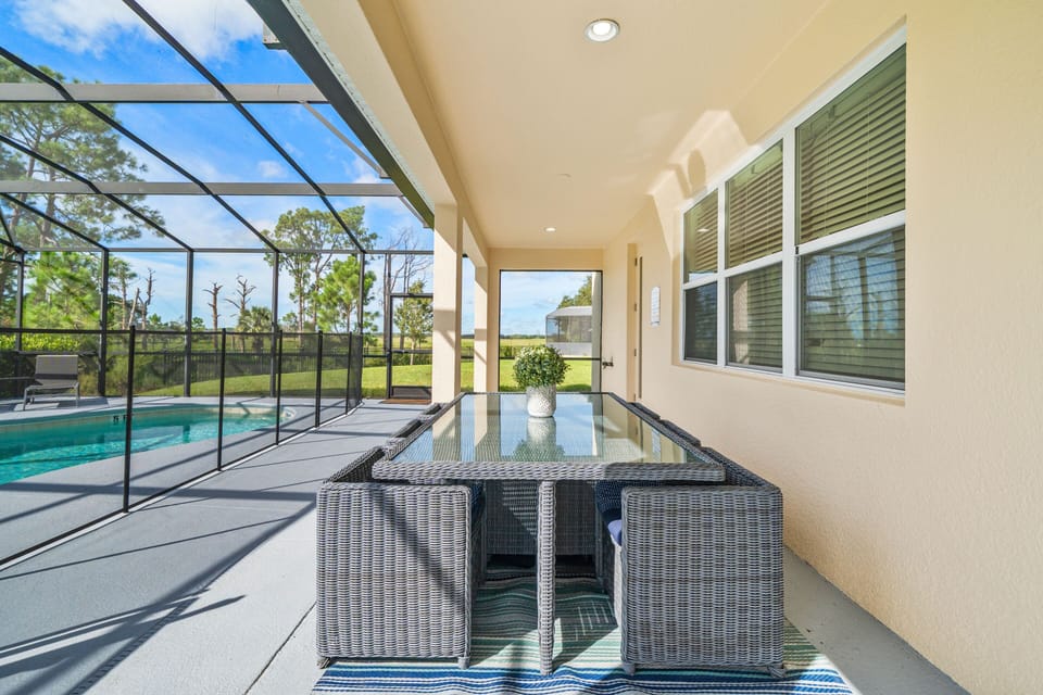 - Covered patio with outdoor dining by the pool  
- Orlando family vacation villa with modern seating  
- Lakeside villa rental near Disney with screened lanai